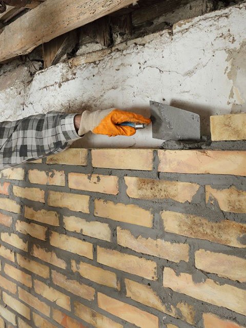 Mason Completing Brick mortar Repair